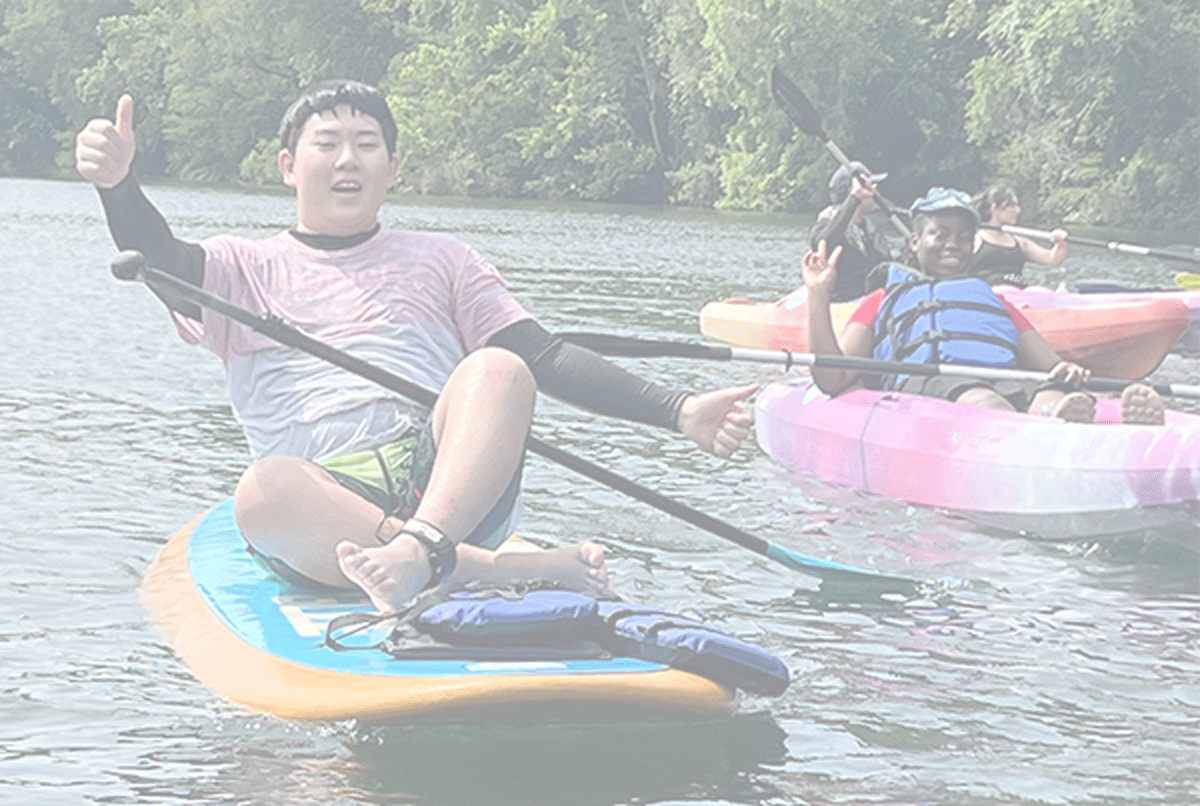 youth paddling on river