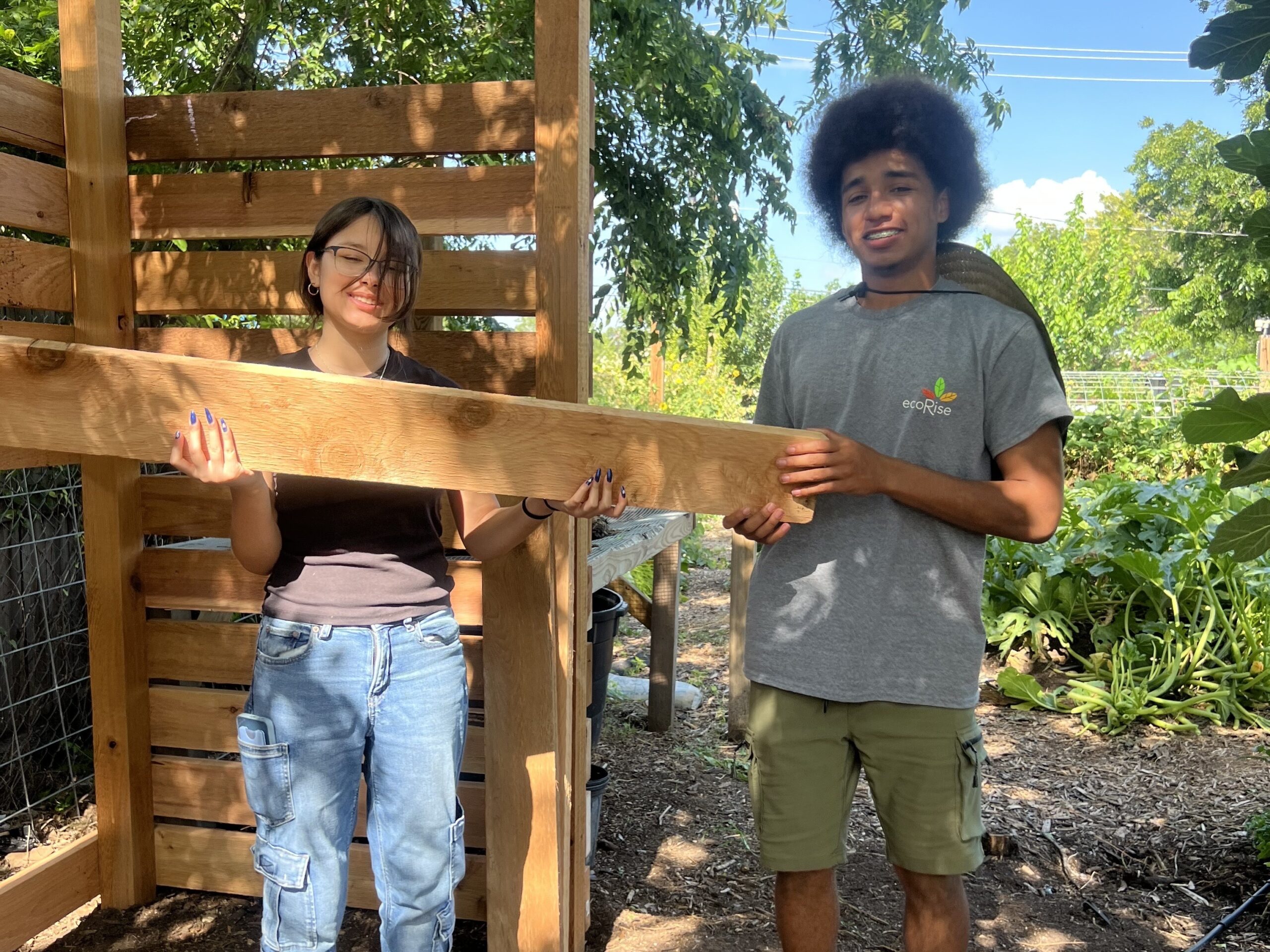 Najia and Dazzel pause for a photo while constructing a new compost bed for Gardopia Gardens.
